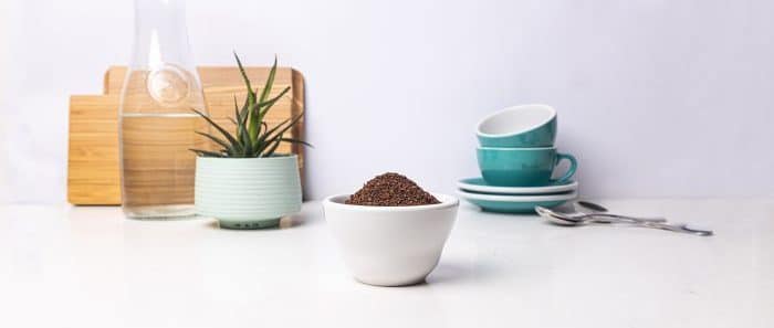 A bowl of ground coffee on a counter.